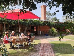 Red umbrella over garden diners