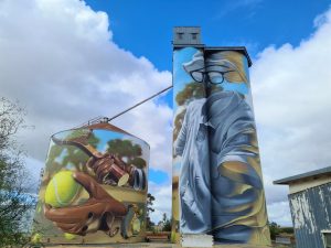 Local tennis player represented across two silos with racquet and ball