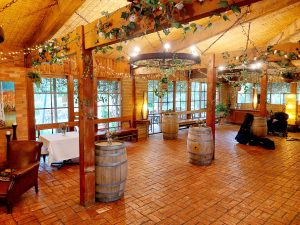 Open floorplan with wine barrels for cocktail food