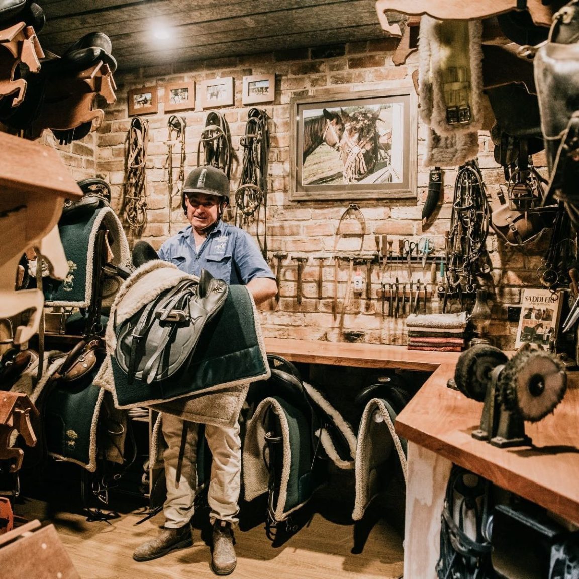 Image of man holding saddle